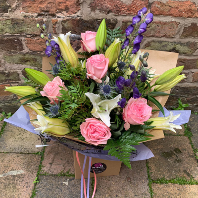 Petal Paradise - A lively bouquet featuring a bright mix of vibrant seasonal blooms. Complemented by lush green foliage and presented in a beautiful packaging, this arrangement is perfect for adding a pop of colour to any occasion Petal Paradise - A lively bouquet featuring a bright mix of vibrant seasonal blooms. Complemented by lush green foliage and presented in a beautiful packaging, this arrangement is perfect for adding a pop of colour to any occasion